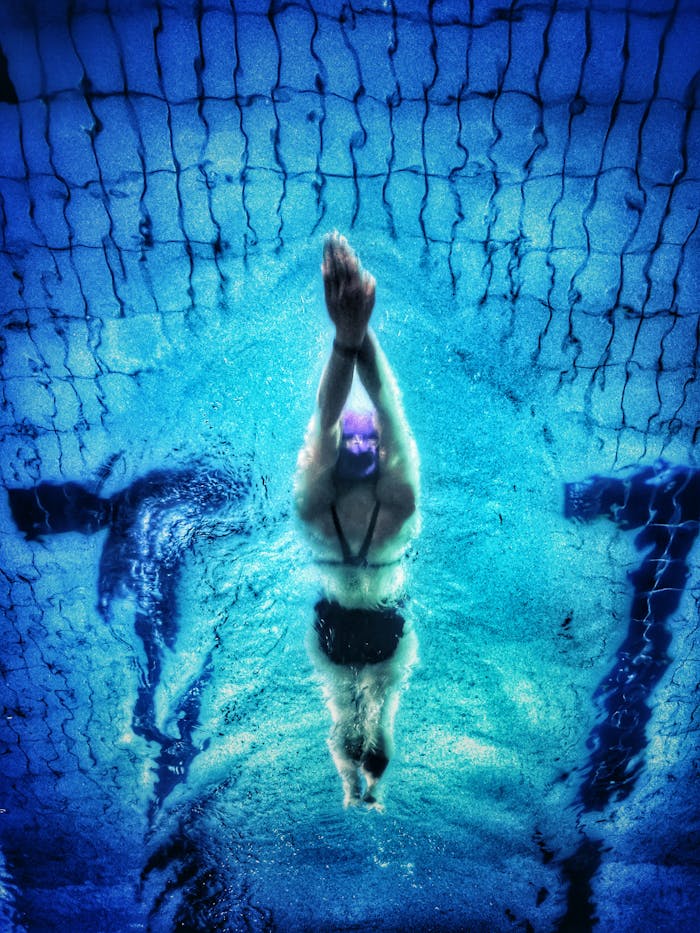 underwater-photography-of-swimmer-711187 Captivating underwater shot of a swimmer in a pool with clear blue water.